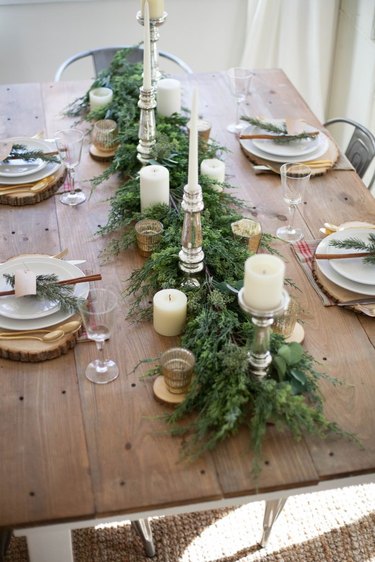 Festive table settings with gold cutlery and silver candlesticks