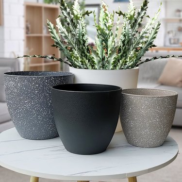 A variety of plastic pots that are imitation stone