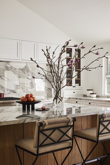 The bright, white kitchen has porcelain countertops.