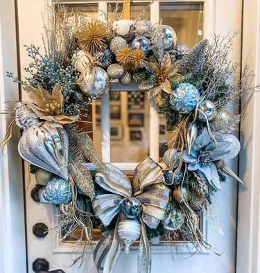 Silver and gold christmas wreath on a front door