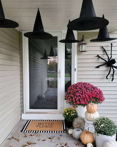 Halloween entryway with witch hats, spider, and pumpkin decorations