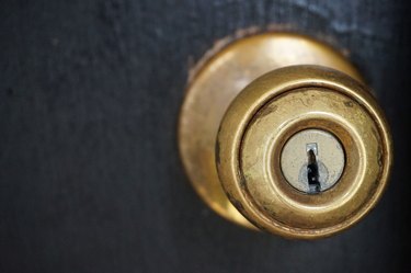 brass doorknob with black door