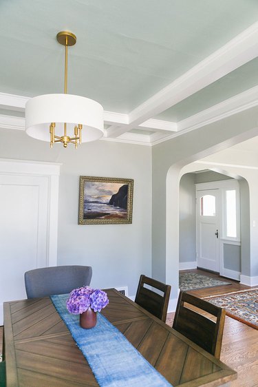 Craftsman style living room with ceiling detail and gold fixtures.