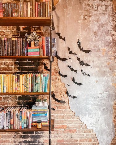 Book shelf next to bat cut-outs