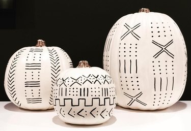 Pumpkins painted white with black geometric shapes