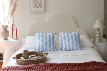 DIY boucle fabric cloud headboard styled with throw pillows and bedroom accessories