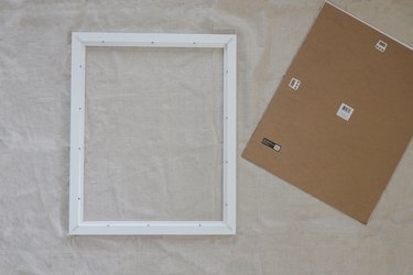 White picture frame with glass and backing removed