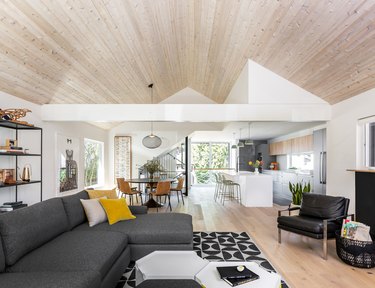 living room area with dark gray couch and bookshelf