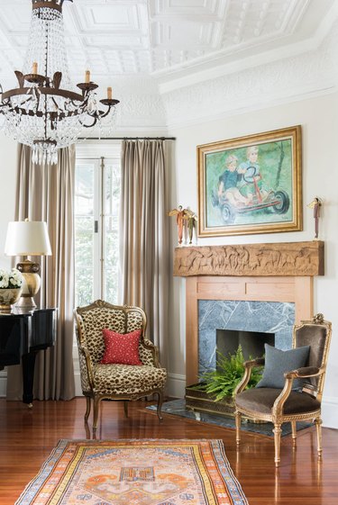 living room with wooden fireplace, vintage seats