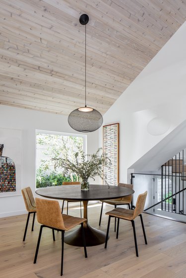 dining area with round table and hanging light fixture