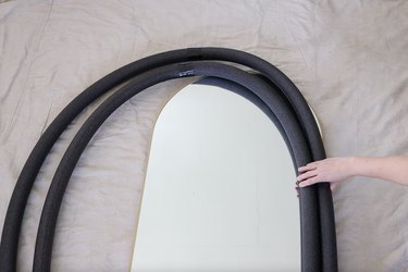Arranging foam pipe tubes on top of mirror to measure