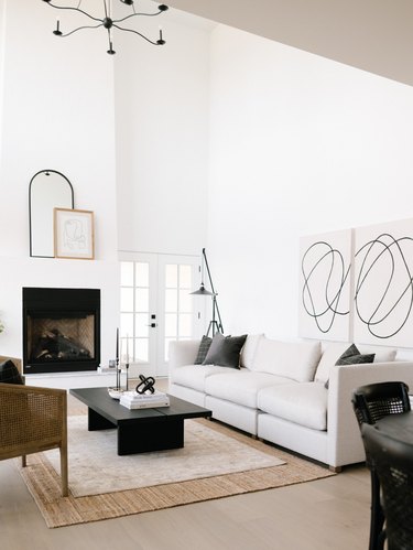 black and white transitional living room with layered rugs