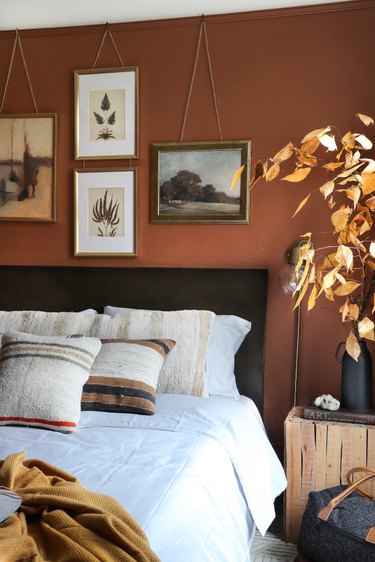 dark orange accent wall in bohemian bedroom