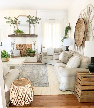 farmhouse living room with dark gray rug on top of white area rug