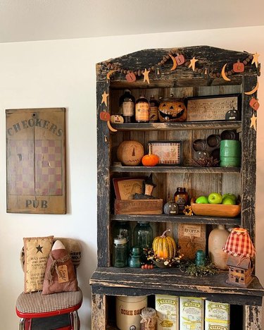 Apothecary-style shelf with autumnal decorations