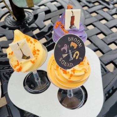 An orange, purple, and yellow Dole Whip flight representing the three Hocus Pocus witches.