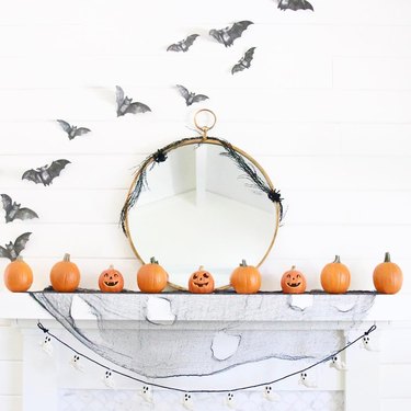 Mantel with pumpkins and bat decorations