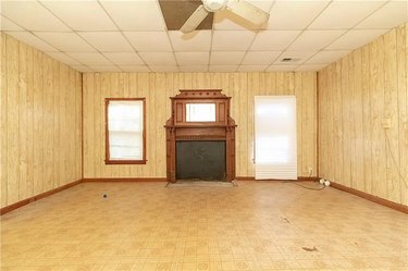 An empty living room with a fireplace