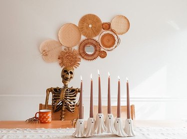 Skeleton at table with candles
