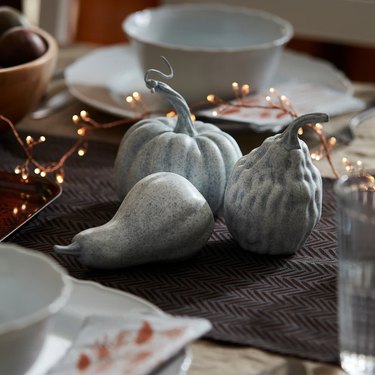 three decorative pumpkins on top of a table