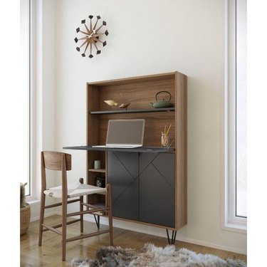 armoire-like secretary desk with wood frame and black cabinet doors