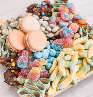 board with candy and macarons