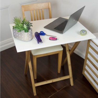 white folding desk with wood legs