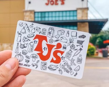 Hand holding Trader Joe's gift card