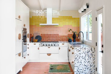 Coral backsplash with white cabinets