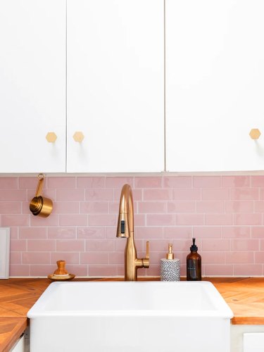 Pink backsplash with white cabinets