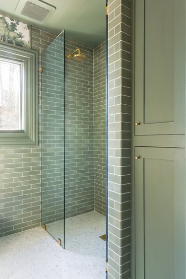 walk-in shower with monochromatic green tile