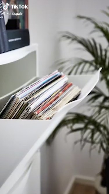 Records being stored in a white IKEA Trones shoe cabinet.