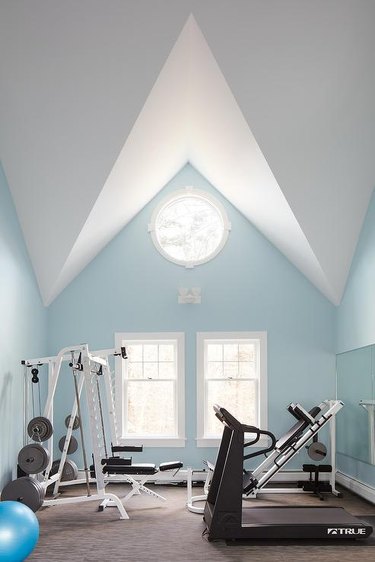workout room with pale blue walls and high ceilings