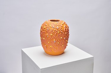 Orange vase with yellow textured speckles