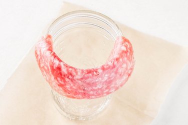 Fold another piece of salami over edge of jar