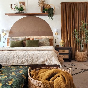 Modern boho bedroom in warm palette and caramel curtain