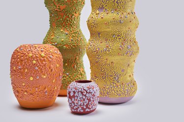 Close-up of 4 colorful vases in various sizes