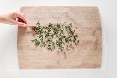 Add chopped herbs to parchment paper