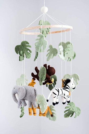 mobile with safari animals and jungle leaves