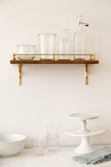 DIY Brass Gallery Shelf in kitchen with glassware