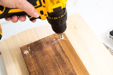 Drilling holes into a wood shelf