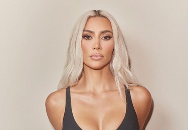 A photo of Kim Kardashian, a woman with platinum blonde long hair.