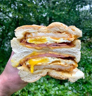 egg sandwich in hand