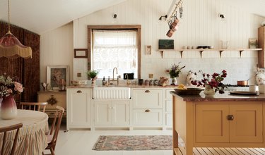 Boho kitchen with farmhouse sink and net curtains