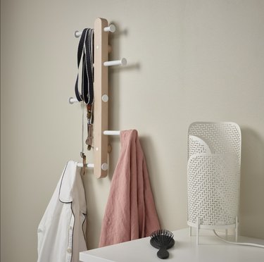 vertical wall rack with jackets and accessories hanging