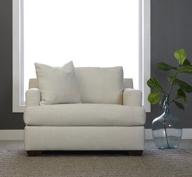 white armchair in living room with plant