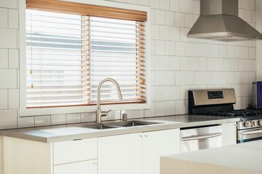 contemporary kitchen with faux wooden blinds above sink