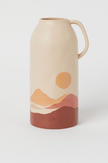 stoneware vase with illustration of mountains and sun