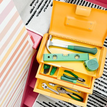yellow toolbox with green tools