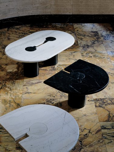 A solid white Tornado marble top sits atop a richly veined Marquina black marble base, creating a compelling study in contrast.